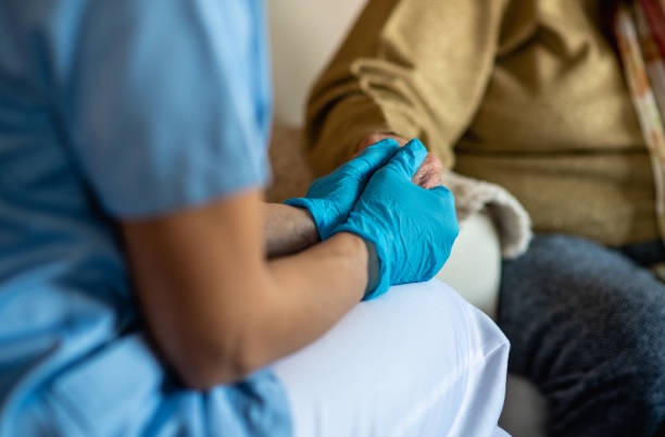 skilled-nursing-5 Nurse in surgical gloves is comforting old woman during check up