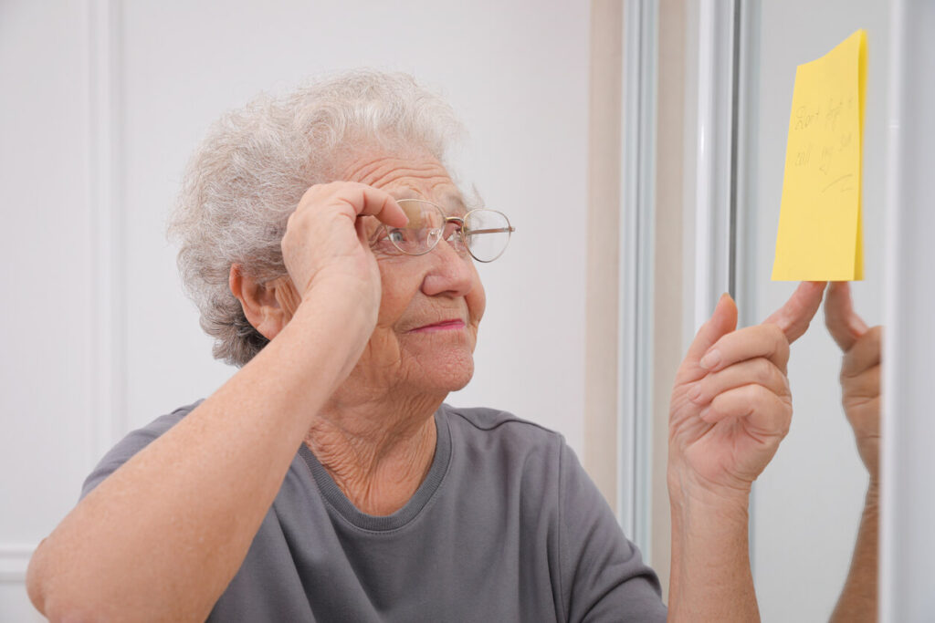 iStock-1415564301-1 Elderly Woman staring at a yellow note