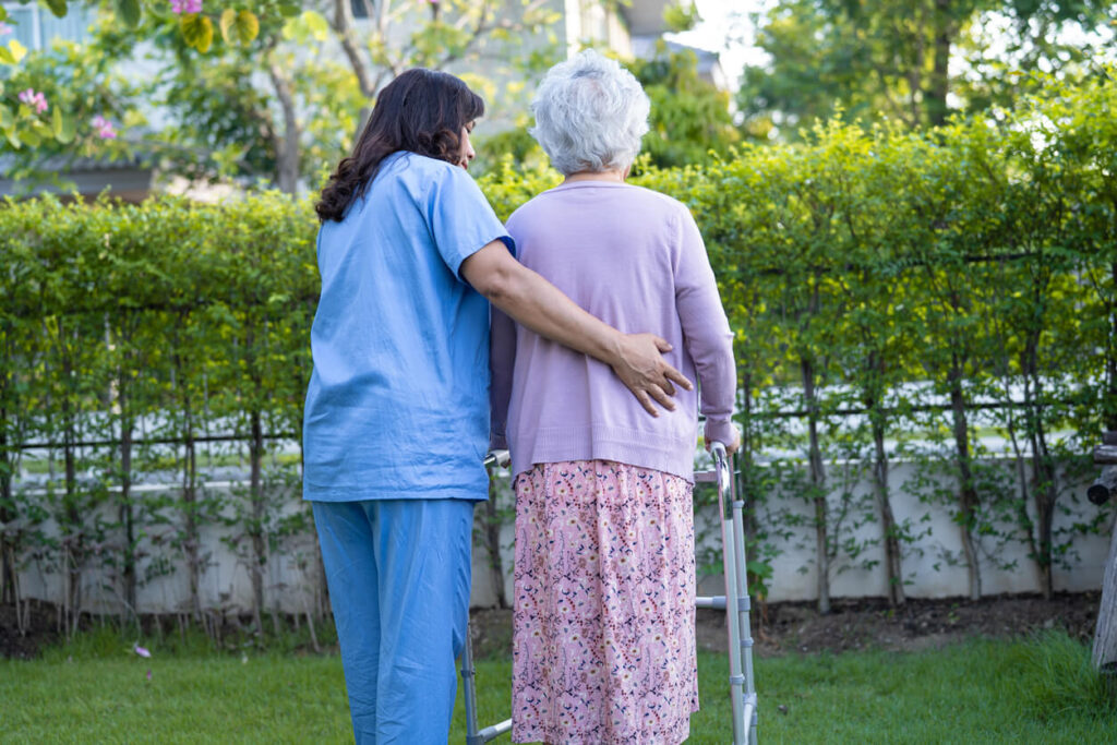 Doctor help and care elderly old lady woman use walker